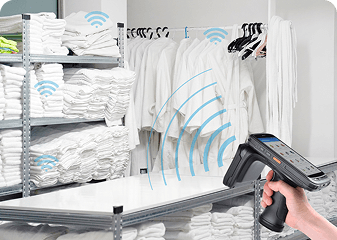 A handheld RFID reader is scanning RFID tags on garments for Laundry Management.
