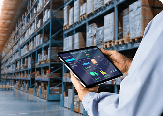 A person uses a RFID tablet device displaying inventory or warehouse management data.